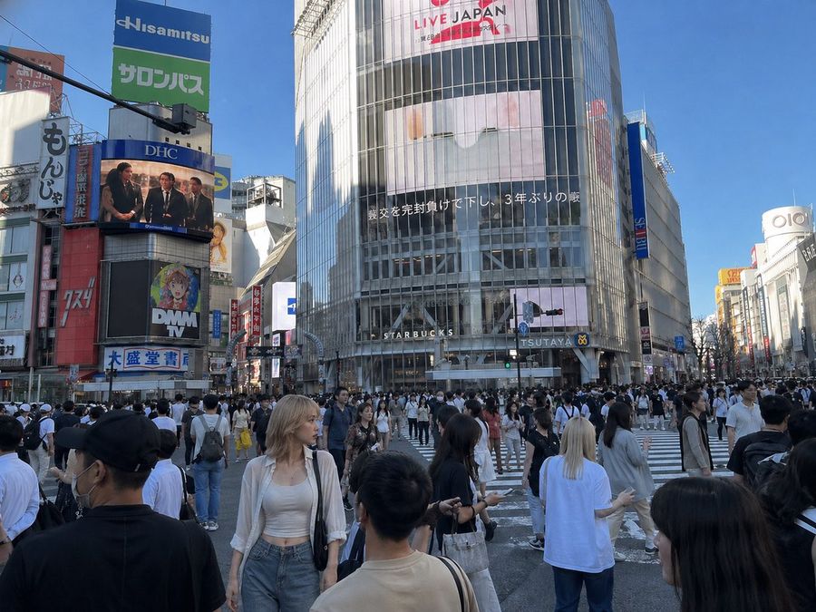 Insert Reference Person Into Shibuya Scene — GPT Image 2 image prompt example
