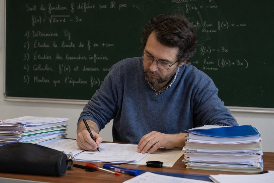 Math Teacher Grading Papers In Classroom — GPT Image 2 image prompt example