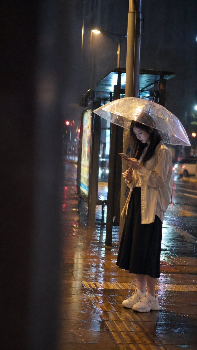 Rainy Night Bus Stop Candid — GPT Image 2 image prompt example