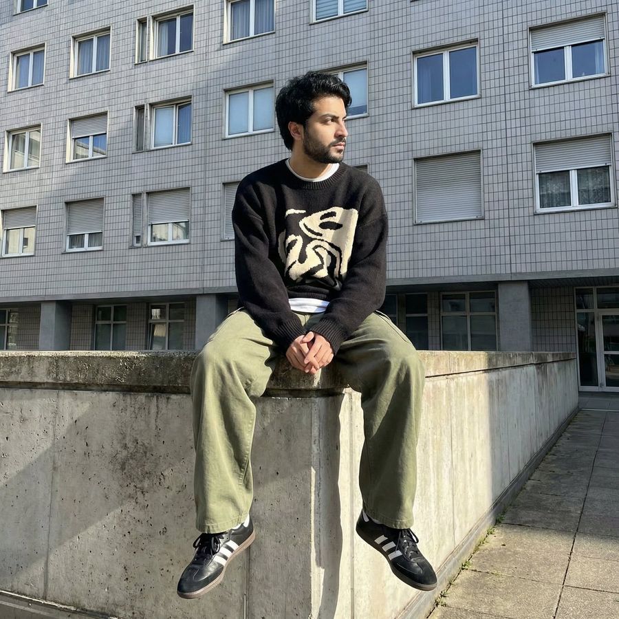 Man from Reference Image 2, Wearing a Dark Sweater with a Distinctive — generated with Nano Banana Pro